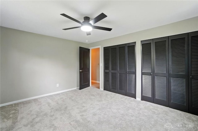 5741 Hithergreen Dr, Washington Twp, OH 45429 - unfurnished bedroom featuring baseboards, carpet flooring, multiple closets, and a ceiling fan