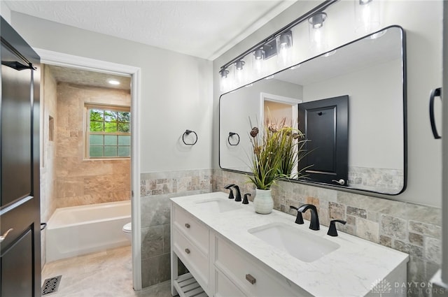 5741 Hithergreen Dr, Washington Twp, OH 45429 - bathroom featuring double vanity, shower / washtub combination, tile walls, and tile patterned floors