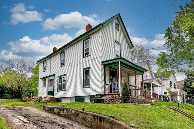 4103 Whetsel Ave, Cincinnati, OH 45227 - view of front facade featuring a chimney, covered porch, a front yard, and entry steps