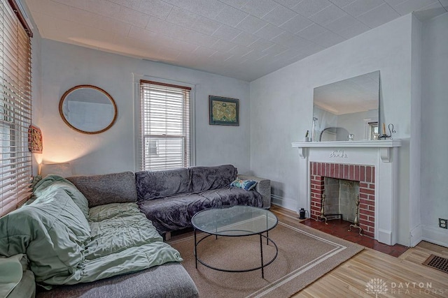 4103 Whetsel Ave, Cincinnati, OH 45227 - living room featuring wood finished floors, a fireplace, and baseboards