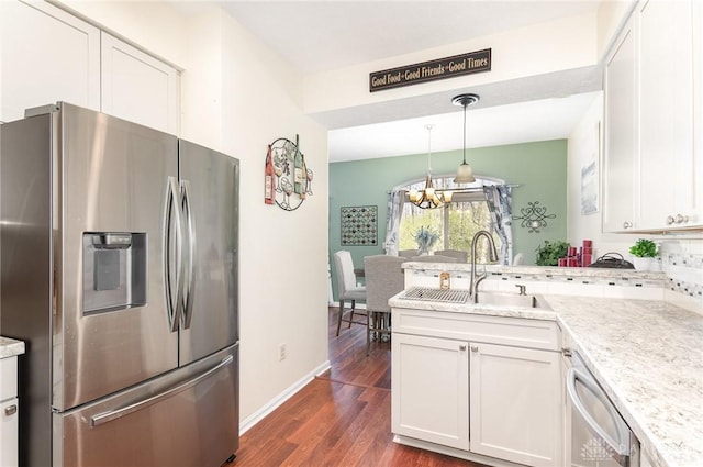 kitchen featuring stainless steel appliances, dark wood finished floors, and white cabinets