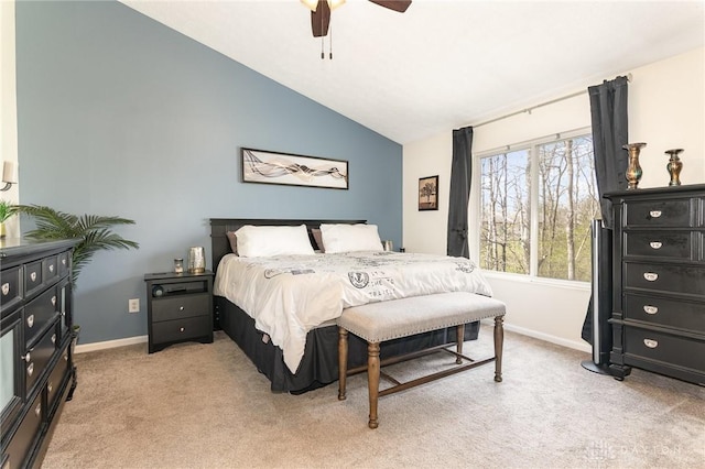 bedroom with light colored carpet, baseboards, lofted ceiling, and ceiling fan