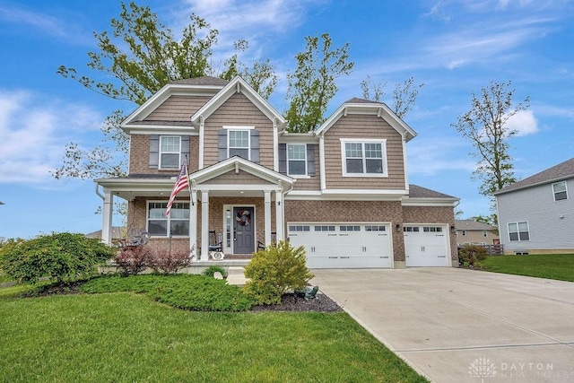 1737 Red Clover Dr, Lebanon, OH 45036 - craftsman house featuring driveway, a front yard, brick siding, an attached garage, and covered porch