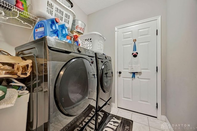 1737 Red Clover Dr, Lebanon, OH 45036 - laundry room featuring washer and clothes dryer, light tile patterned flooring, and baseboards