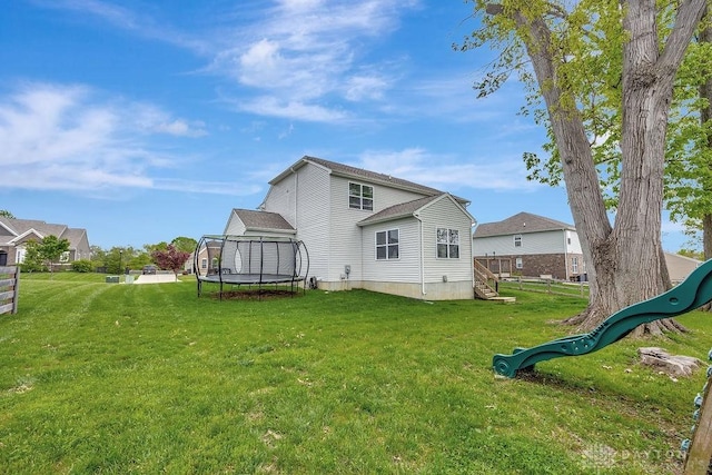 1737 Red Clover Dr, Lebanon, OH 45036 - back of property featuring a trampoline, a yard, and a playground