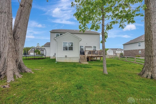 1737 Red Clover Dr, Lebanon, OH 45036 - rear view of house with a trampoline and a wooden deck