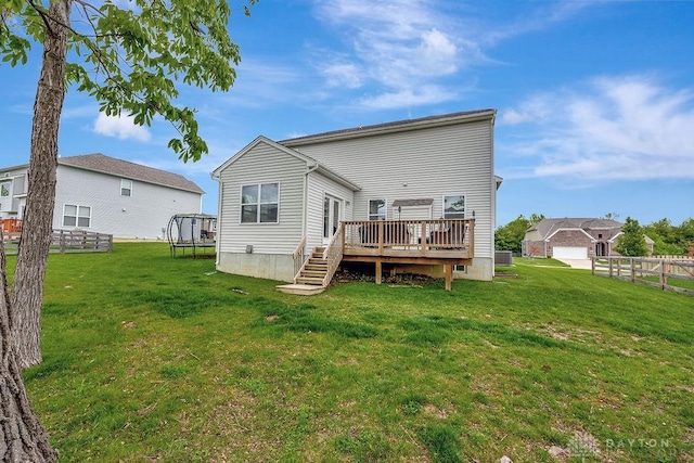 1737 Red Clover Dr, Lebanon, OH 45036 - rear view of house with a trampoline and a wooden deck