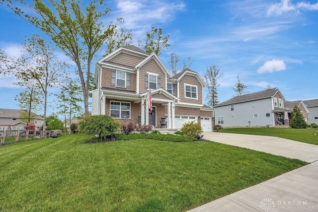 1737 Red Clover Dr, Lebanon, OH 45036 - craftsman inspired home featuring an attached garage, concrete driveway, brick siding, and a front lawn