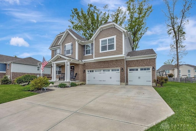 1737 Red Clover Dr, Lebanon, OH 45036 - craftsman house featuring covered porch, concrete driveway, brick siding, and a garage