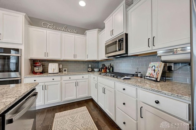 1737 Red Clover Dr, Lebanon, OH 45036 - kitchen featuring appliances with stainless steel finishes, white cabinets, backsplash, dark wood-style floors, and recessed lighting
