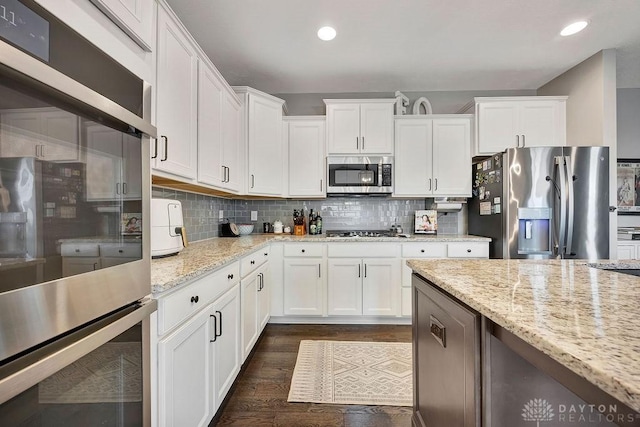 1737 Red Clover Dr, Lebanon, OH 45036 - kitchen featuring appliances with stainless steel finishes, white cabinets, tasteful backsplash, dark wood-style flooring, and recessed lighting