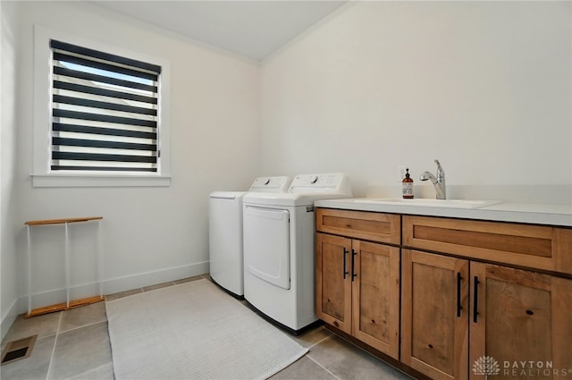 9917 Rothschild Ct, Clearcreek Twp, OH 45458 - clothes washing area featuring independent washer and dryer, tile patterned floors, and cabinet space