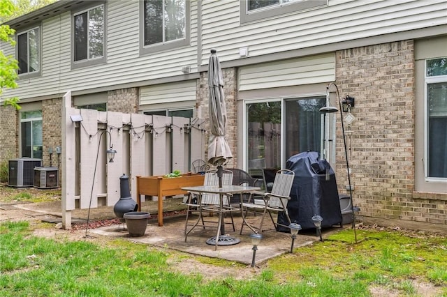 view of patio / terrace with a grill and cooling unit