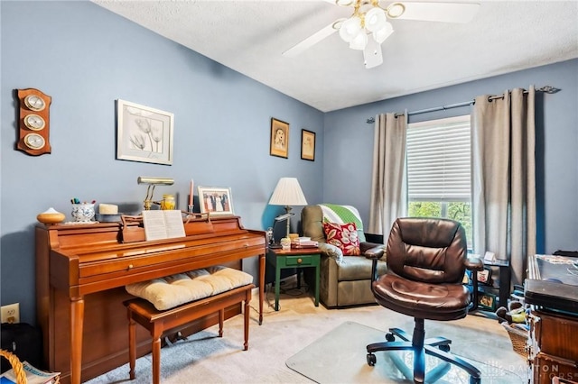 carpeted office featuring a ceiling fan