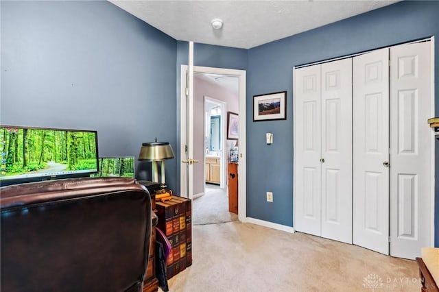 office area featuring light colored carpet and baseboards