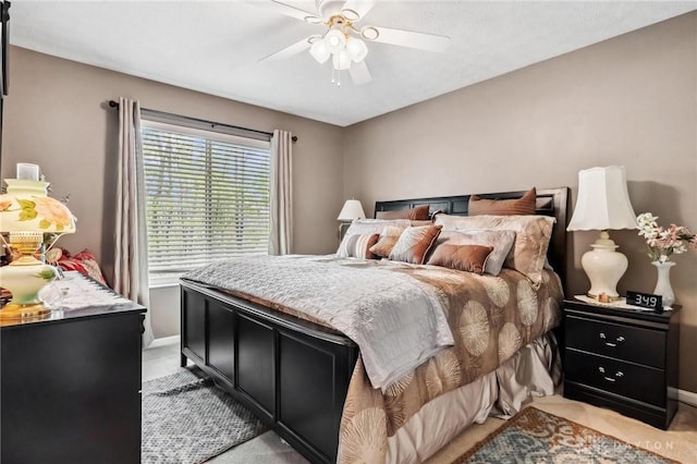 bedroom with ceiling fan and baseboards