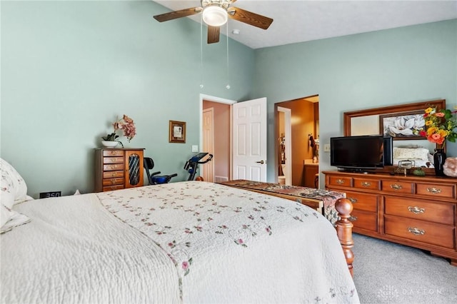 bedroom featuring light colored carpet, high vaulted ceiling, a ceiling fan, and connected bathroom