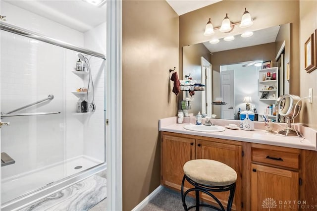 full bath with a shower stall and vanity