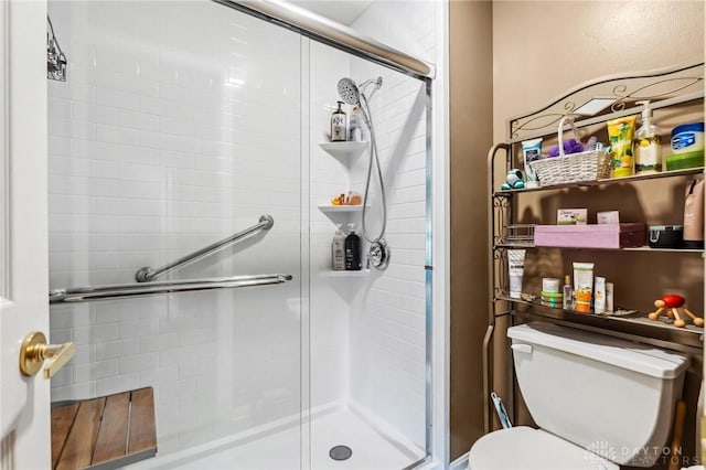 full bath with toilet and a stall shower