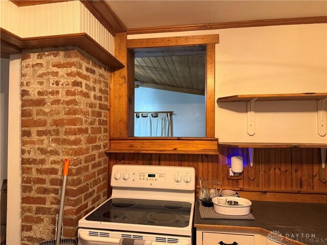 2 Brompton Ln, Cincinnati, OH 45218 - kitchen with white range with electric stovetop, crown molding, and dark countertops