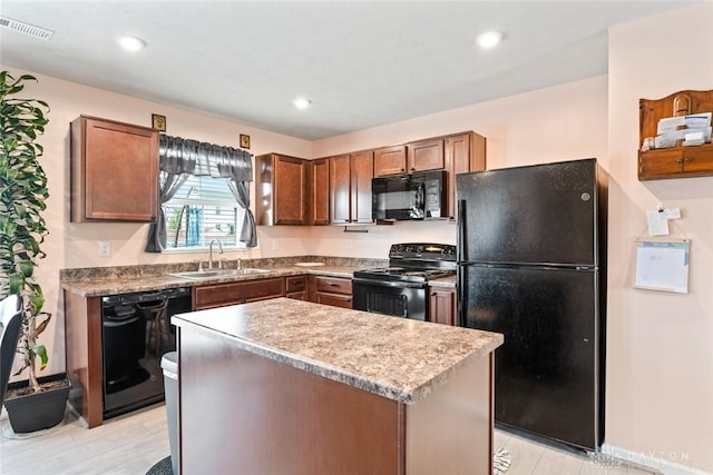 1194 Lisa Marie Dr, Xenia, OH 45385 - kitchen featuring black appliances, a sink, a center island, recessed lighting, and brown cabinetry