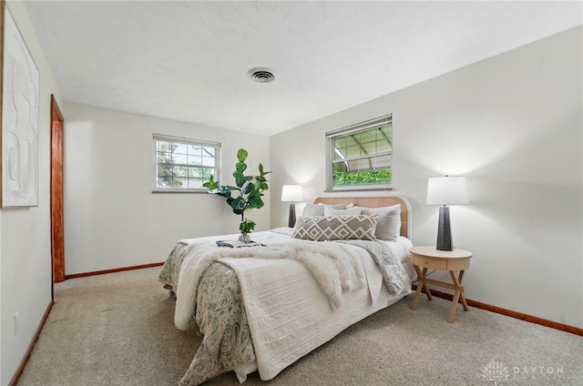 bedroom featuring carpet and baseboards