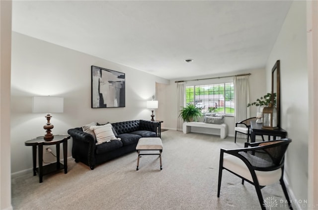 carpeted living room with baseboards