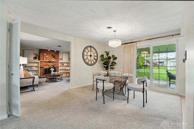 dining space featuring carpet flooring, a chandelier, and baseboards