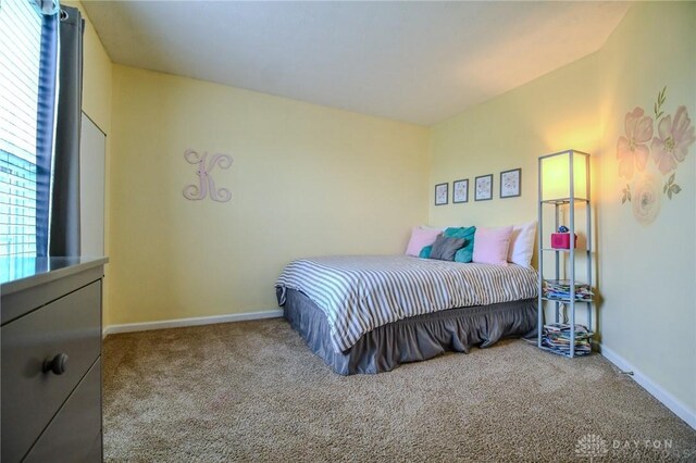 carpeted bedroom featuring baseboards