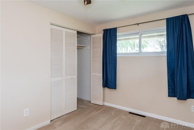 3762 Waterbury Dr, Kettering, OH 45439 - unfurnished bedroom with carpet floors, a closet, and baseboards