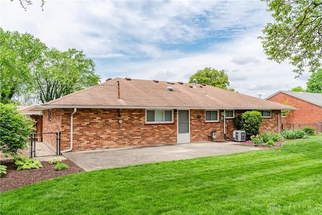 3762 Waterbury Dr, Kettering, OH 45439 - rear view of house with central air condition unit, a patio area, a gate, and brick siding