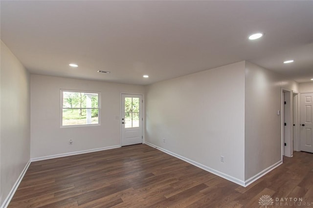 unfurnished room with dark wood-style floors, baseboards, and recessed lighting