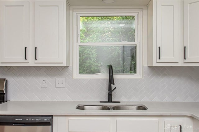 kitchen with dishwasher, a sink, light countertops, backsplash, and white cabinetry