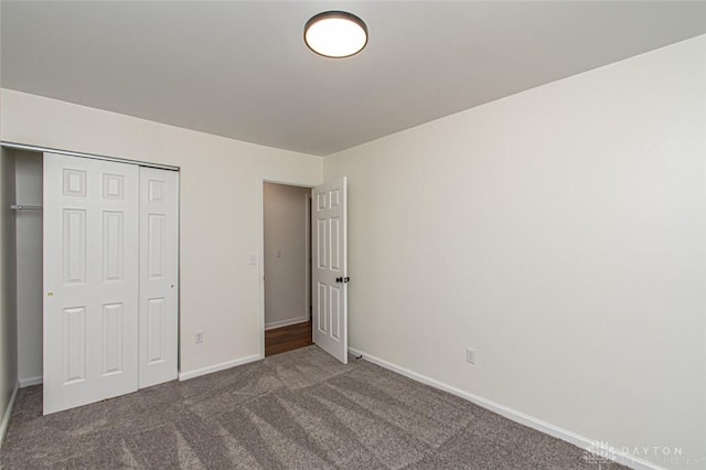 unfurnished bedroom featuring carpet flooring, baseboards, and a closet