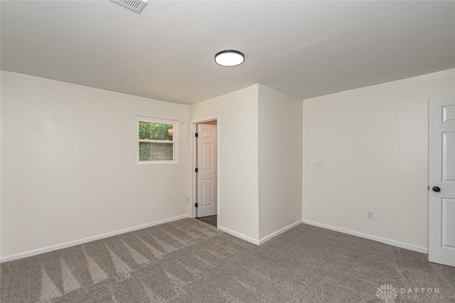 spare room with carpet flooring and baseboards