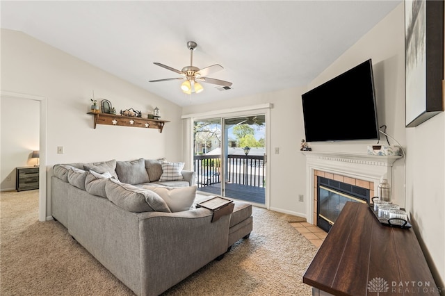 108 Mallard Glen Dr Unit 7, Dayton, OH 45458 - living area featuring ceiling fan, a tiled fireplace, vaulted ceiling, baseboards, and light carpet