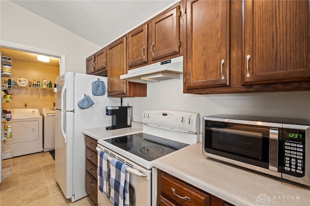 108 Mallard Glen Dr Unit 7, Dayton, OH 45458 - kitchen with white electric range, under cabinet range hood, stainless steel microwave, washer and clothes dryer, and light countertops