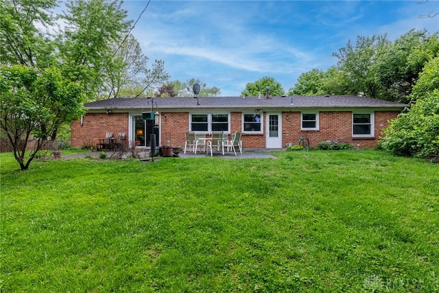 2084 Firebird Dr, Bellbrook, OH 45305 - back of house with a patio area, brick siding, and a lawn
