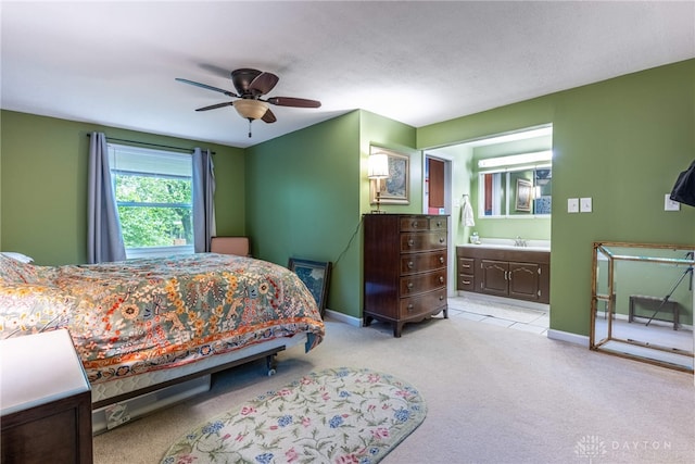 2084 Firebird Dr, Bellbrook, OH 45305 - bedroom with light colored carpet, baseboards, a sink, and ensuite bath
