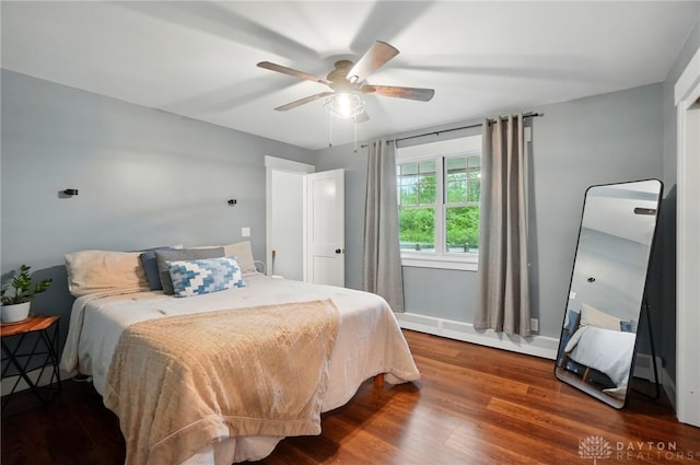 2023 W State Route 63, Lebanon, OH 45036 - bedroom featuring baseboard heating, wood finished floors, and a ceiling fan