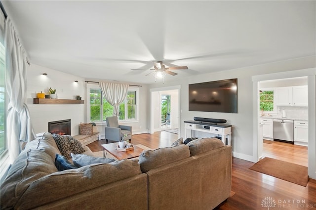 2023 W State Route 63, Lebanon, OH 45036 - living room with a glass covered fireplace, light wood-type flooring, ceiling fan, and baseboards