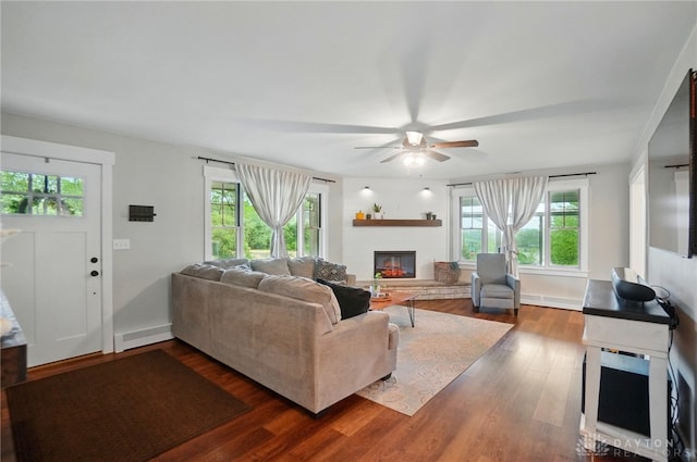 2023 W State Route 63, Lebanon, OH 45036 - living room with plenty of natural light, a ceiling fan, a glass covered fireplace, and dark wood finished floors