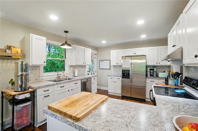 2023 W State Route 63, Lebanon, OH 45036 - kitchen featuring stainless steel appliances, range hood, a sink, decorative backsplash, and recessed lighting