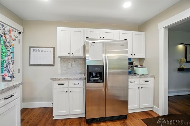 2023 W State Route 63, Lebanon, OH 45036 - kitchen featuring stainless steel refrigerator with ice dispenser, dark wood-type flooring, decorative backsplash, white cabinets, and light stone counters