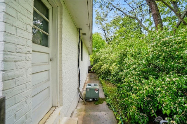 2023 W State Route 63, Lebanon, OH 45036 - view of side of home featuring central air condition unit, brick siding, and a garage