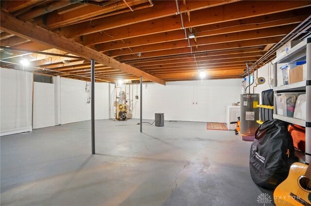 2023 W State Route 63, Lebanon, OH 45036 - unfinished below grade area featuring electric water heater, a heating unit, and washer / dryer