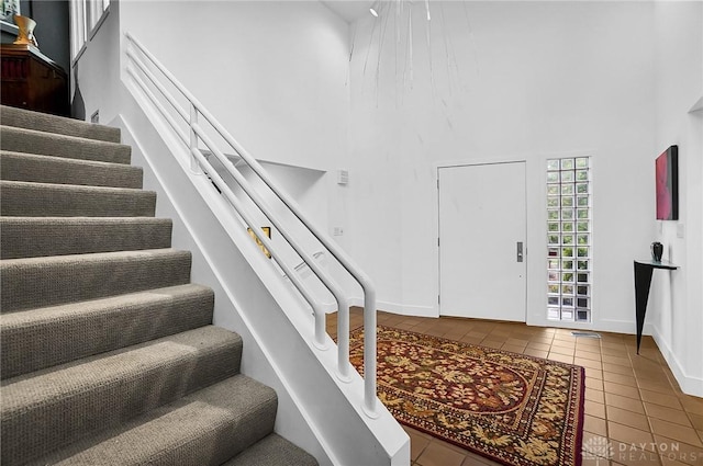 1900 Kresswood Cir, Kettering, OH 45429 - entryway with a high ceiling, tile patterned floors, stairs, and baseboards