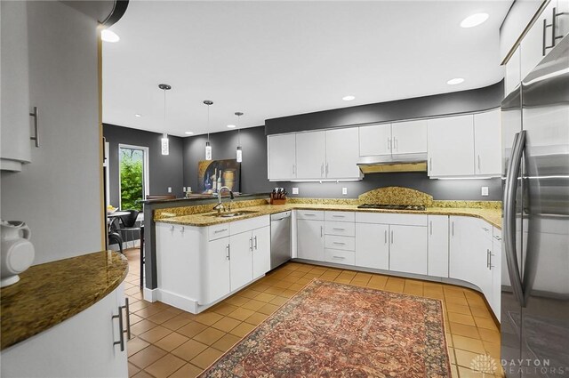 1900 Kresswood Cir, Kettering, OH 45429 - kitchen with stainless steel appliances, a sink, a peninsula, tile patterned flooring, and under cabinet range hood