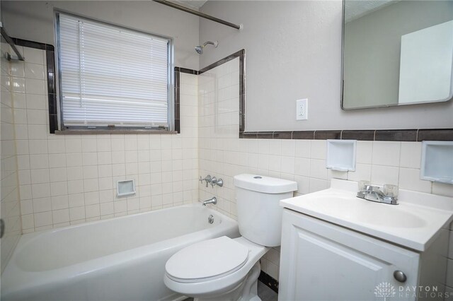 2525 Lakeview Ave, Dayton, OH 45417 - full bath featuring toilet, vanity, tub / shower combination, and tile walls