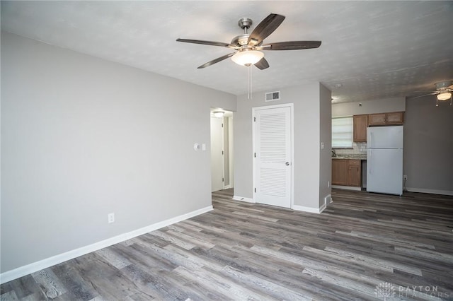 2525 Lakeview Ave, Dayton, OH 45417 - unfurnished living room with ceiling fan, dark wood-type flooring, and baseboards